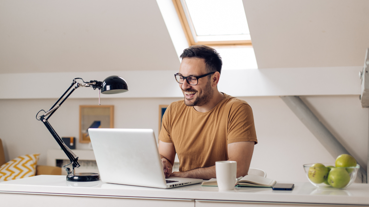 public sector worker working remotely from home, with a laptop and cup of tea-Hybrid work solutions