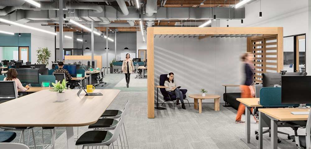 Modern hybrid office space in UK public sector building with flexible desks and video conferencing setup-Hybrid work solutions